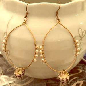 Shell earrings on gold oval hoop